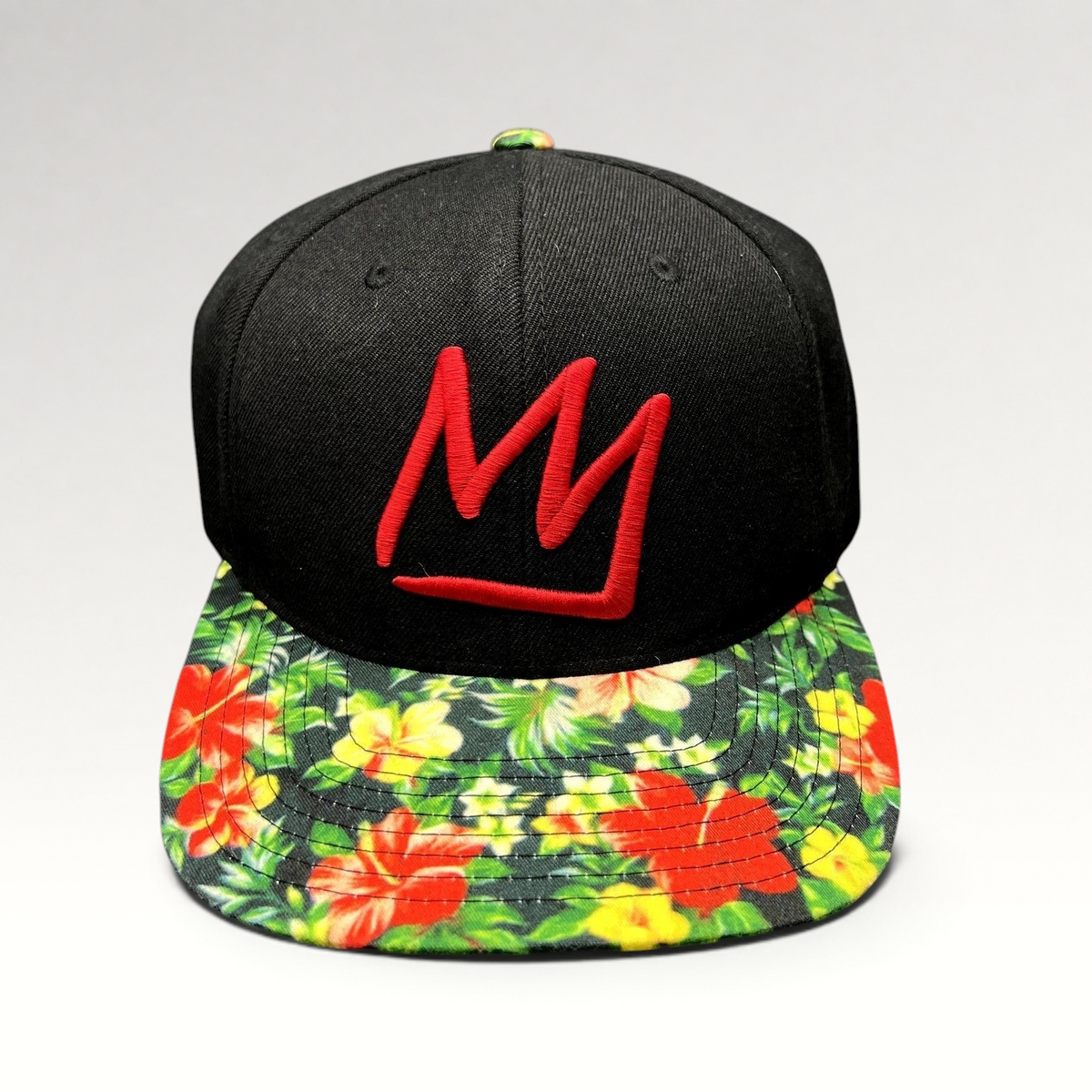 Raree Finds Mammoth Mountain snapback hat with a black crown, red embroidered logo, and tropical floral flat brim.