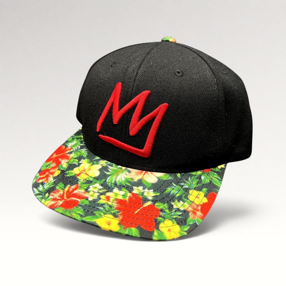 Raree Finds black snapback hat with a red embroidered Mammoth logo and a vibrant tropical floral print flat brim.