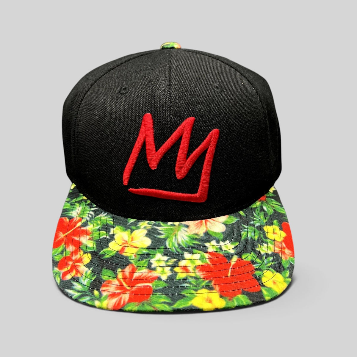 Raree Finds Mammoth Mountain snapback hat with a black crown, red embroidered logo, and tropical floral flat brim.