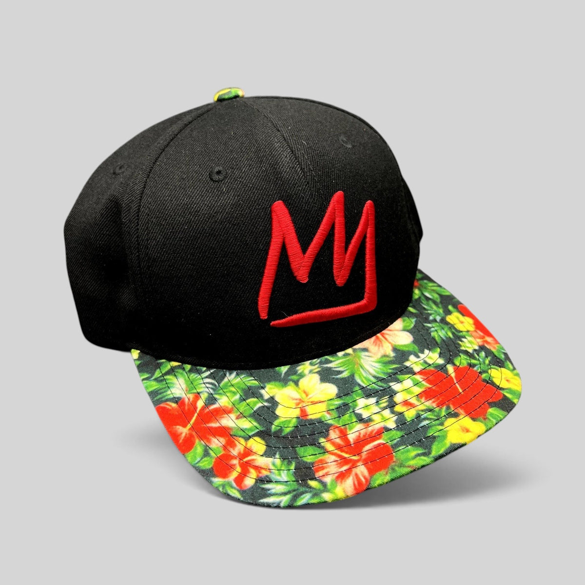 Raree Finds black snapback hat with a red embroidered Mammoth Mountain logo and a vibrant tropical floral flat brim.