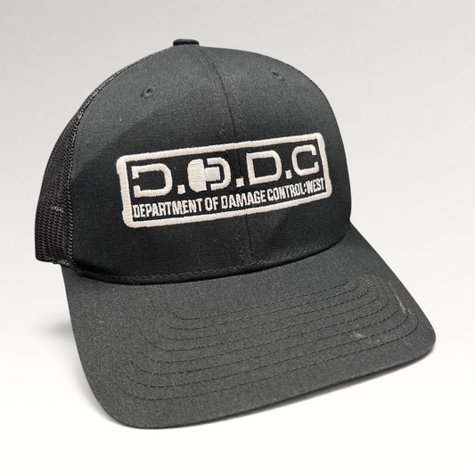 Raree Finds black Marvel Damage Control trucker hat with D.O.D.C. West patch and adjustable snapback closure