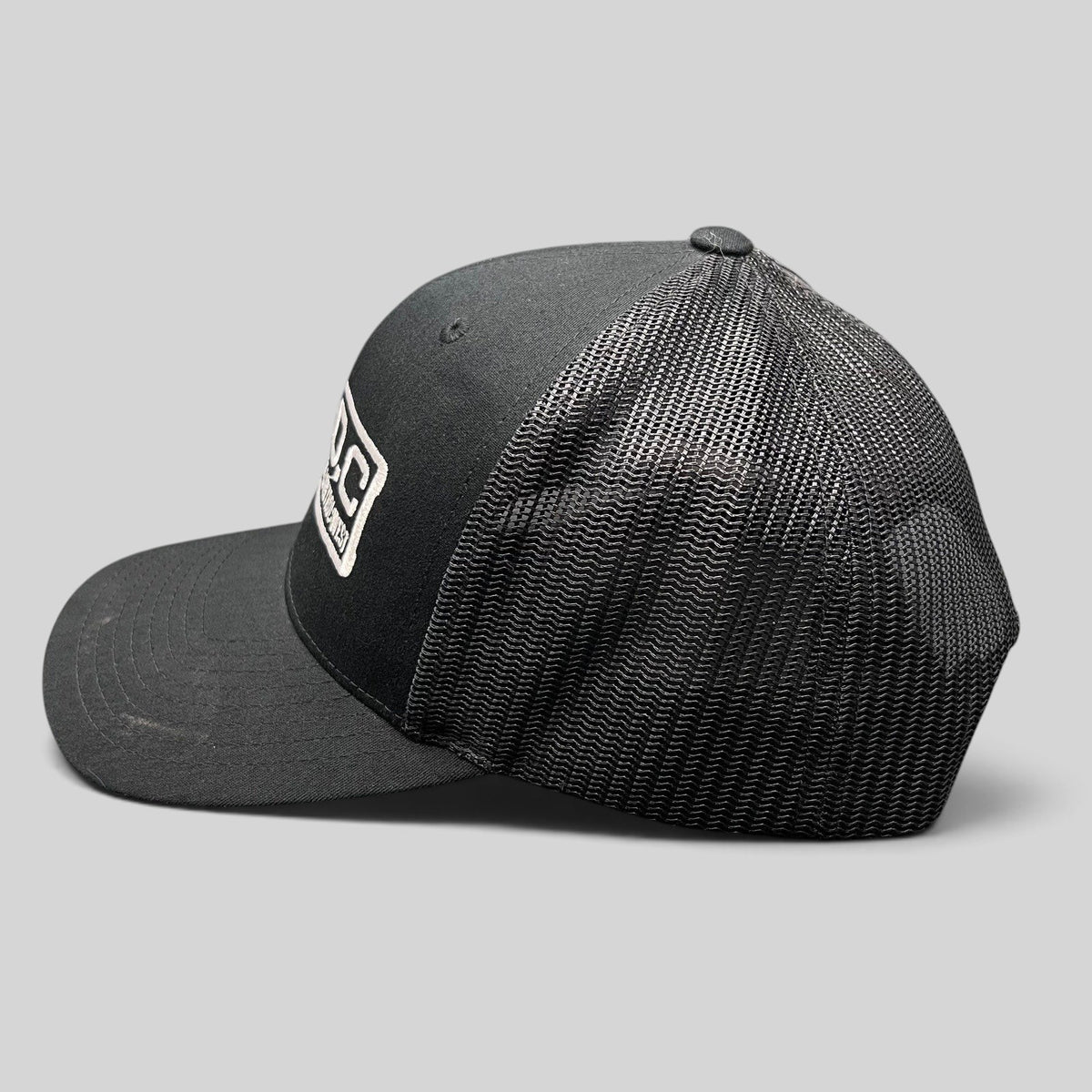 Raree Finds black Marvel Damage Control West trucker snapback hat with mesh back panels and adjustable closure