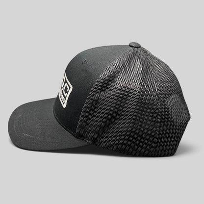 Raree Finds black Marvel Damage Control West trucker snapback hat with mesh back panels and adjustable closure