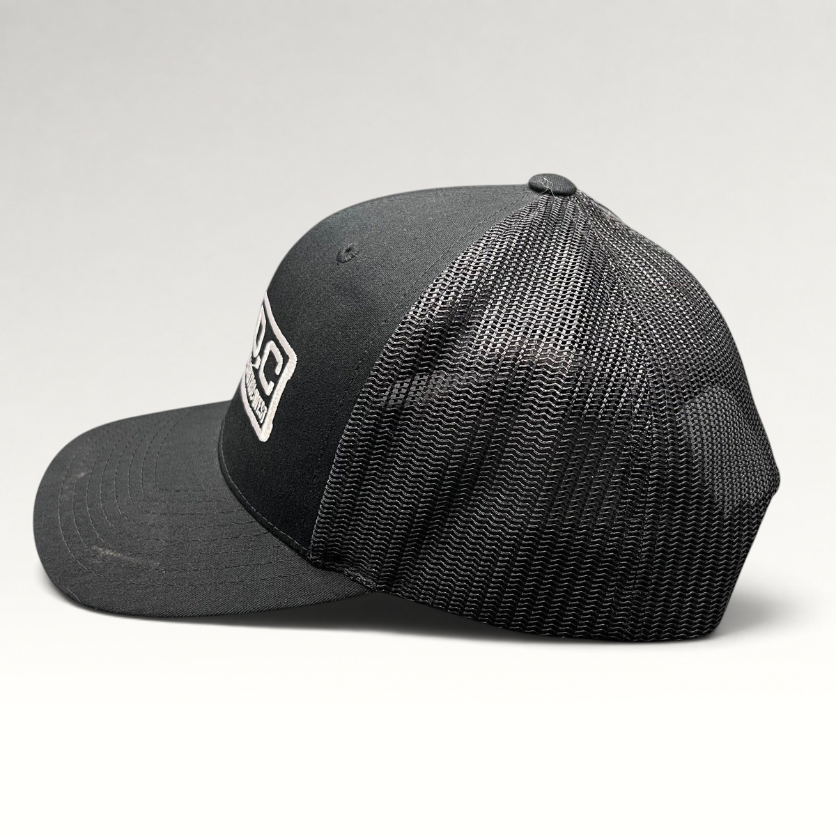 Raree Finds black Marvel Damage Control West trucker snapback hat with mesh back panels and adjustable closure