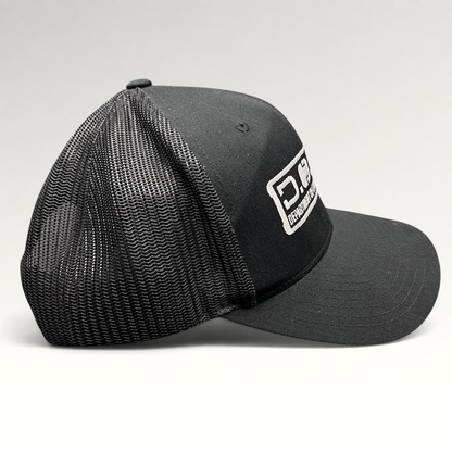 Raree Finds Marvel Damage Control black trucker hat with mesh back and D.O.D.C. West patch, side profile view.