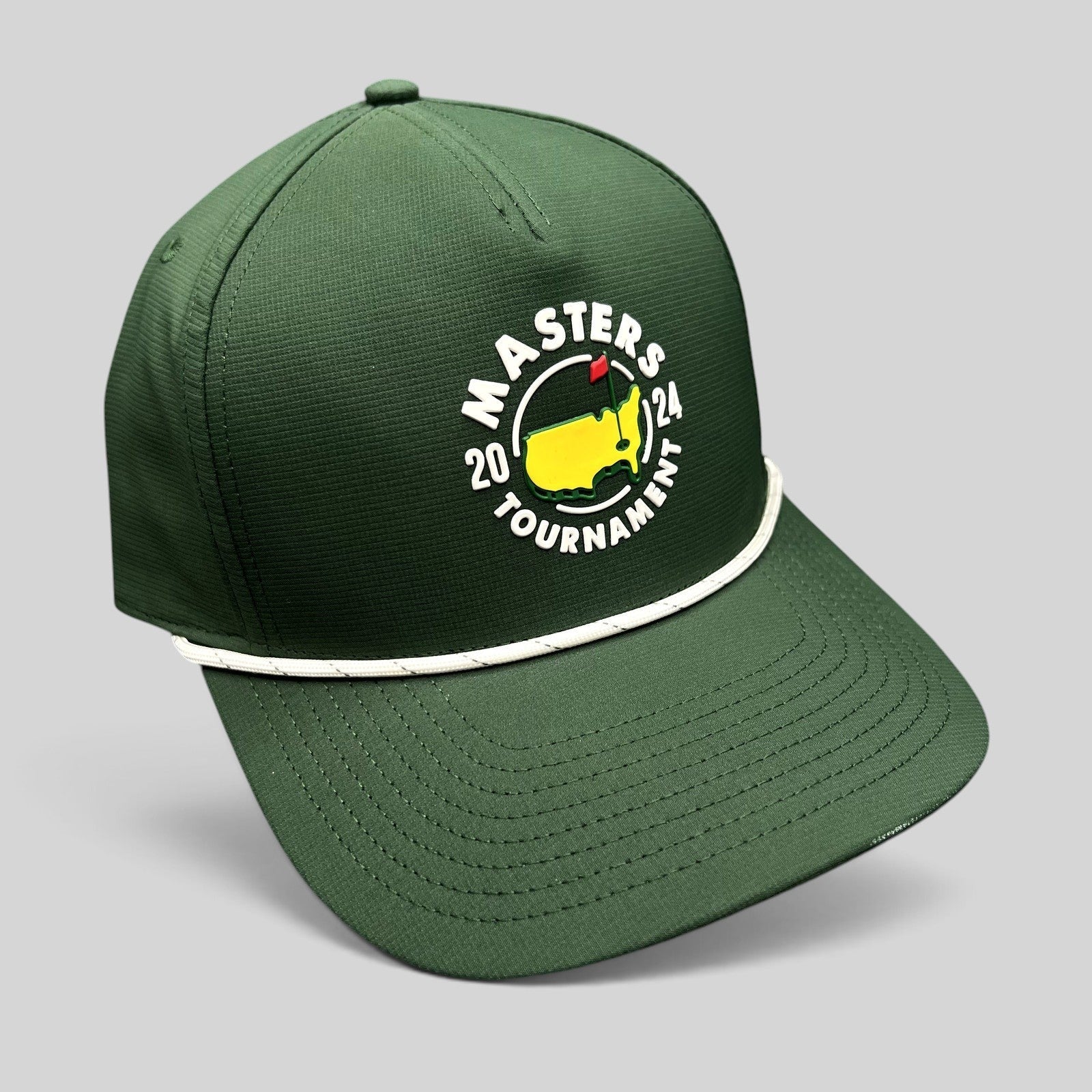 Raree Finds 2024 Masters Tournament green snapback golf hat with white rope detail and official logo on black background
