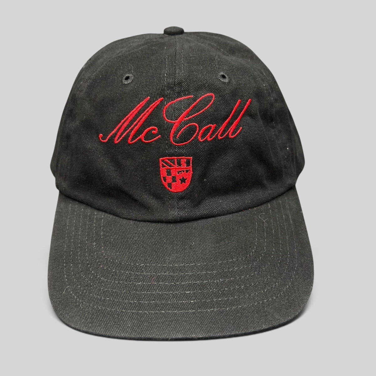 Raree Finds McCall Motor Works black strapback hat with red script embroidery and crest on the front crown