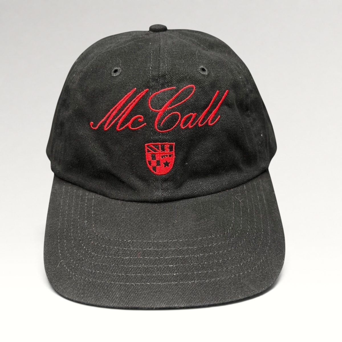 Raree Finds McCall Motor Works black strapback hat with red script embroidery and crest on the front crown