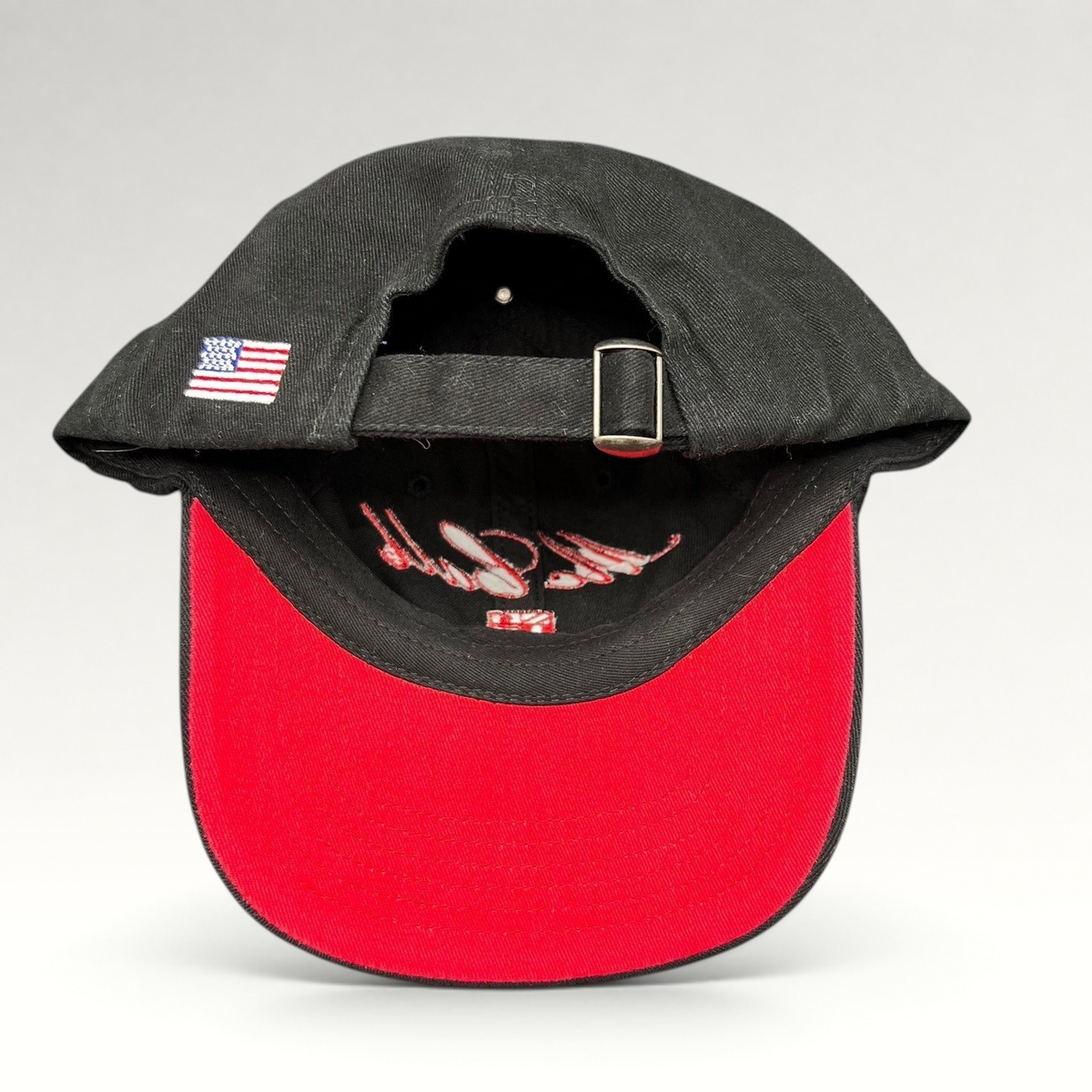 Raree Finds McCall Motor Works black strapback hat with red underbrim and embroidered USA flag on the rear strap