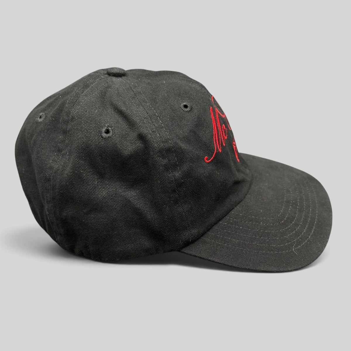 Raree Finds McCall Motor Works black strapback hat with red script embroidery and a matching red underbrim