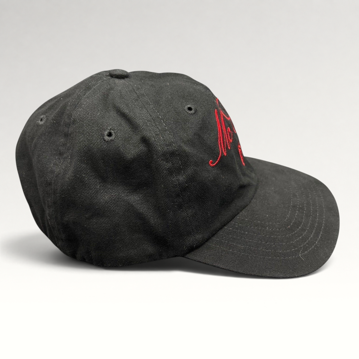 Raree Finds McCall Motor Works black strapback hat with red script embroidery and a matching red underbrim