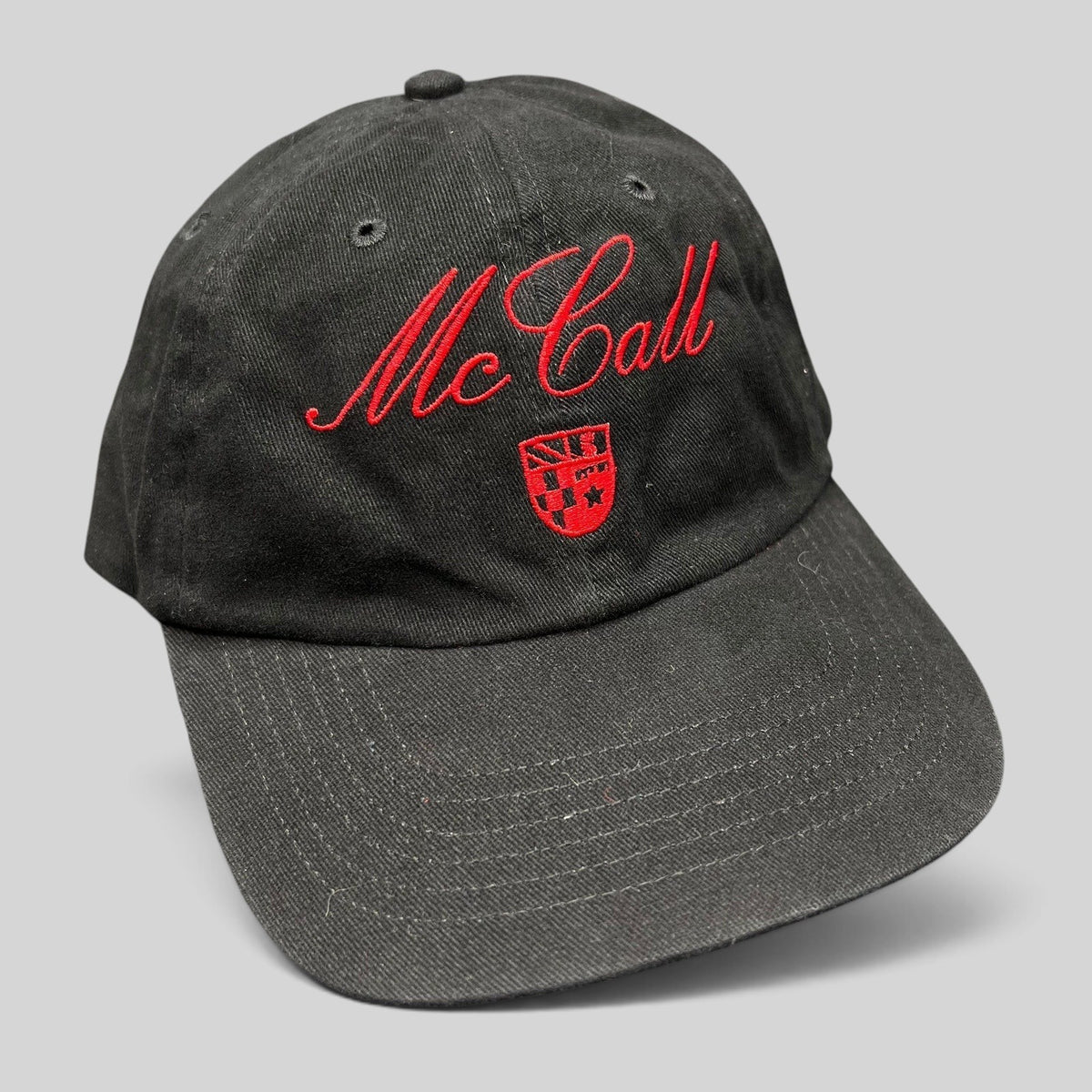 Raree Finds McCall Motor Works black strapback hat with red script embroidery and a small crest on the front crown.