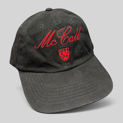 Raree Finds McCall Motor Works black strapback hat with red script embroidery and a small crest on the front crown.