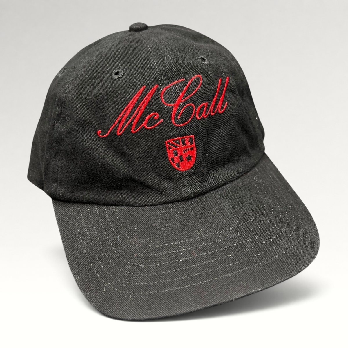 Raree Finds McCall Motor Works black strapback hat with red script embroidery and a small crest on the front crown.