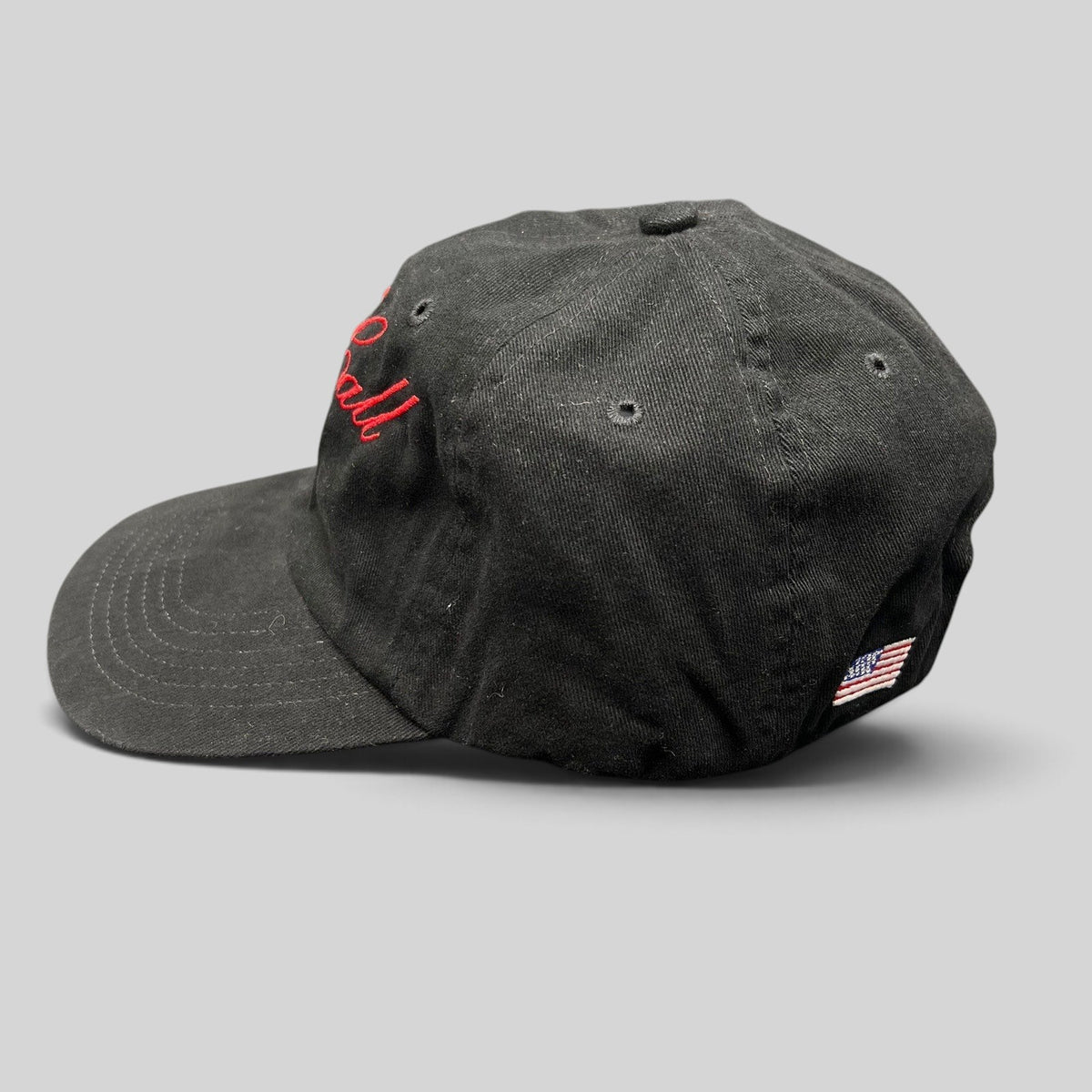 Raree Finds McCall Motor Works black strapback hat with red script embroidery and side American flag detail