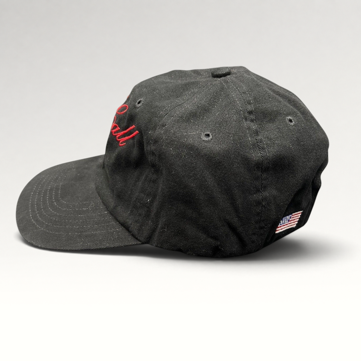 Raree Finds McCall Motor Works black strapback hat with red script embroidery and side American flag detail
