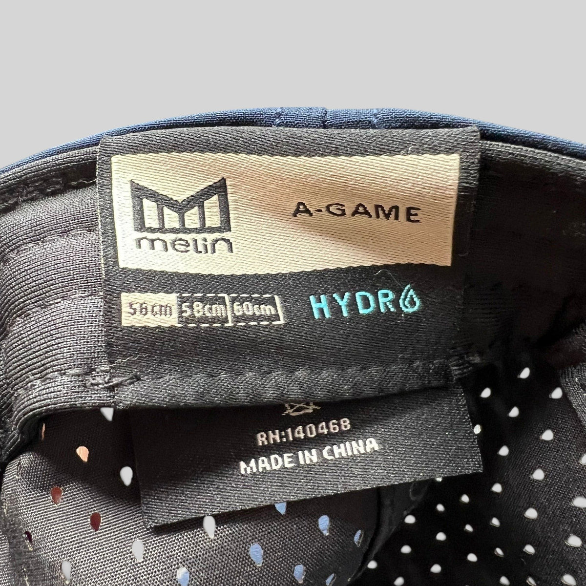 Raree Finds Melin A-Game HYDRO snapback hat interior label showing size and performance fabric details