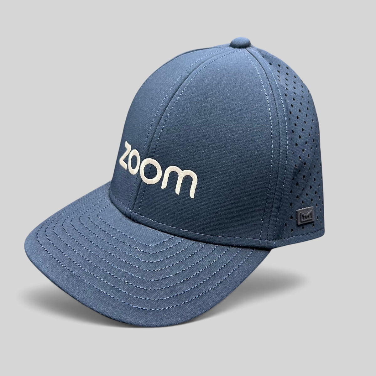 Raree Finds navy Melin Hydro A-Game snapback hat with Zoom embroidery, laser-perforated side panels, and structured fit