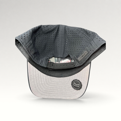 Raree Finds Melin Leave the World Behind snapback hat showing the perforated grey crown and adjustable strap interior.