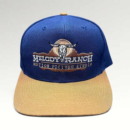 Raree Finds vintage Melody Ranch Motion Picture Studio navy and tan snapback hat with embroidered longhorn skull logo.