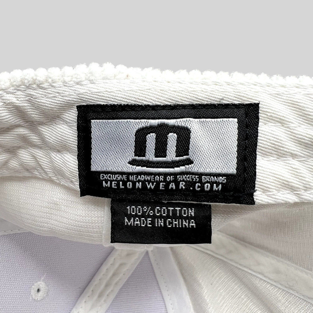 Raree Finds Melonwear white corduroy hat interior label showing 100 percent cotton material and brand branding