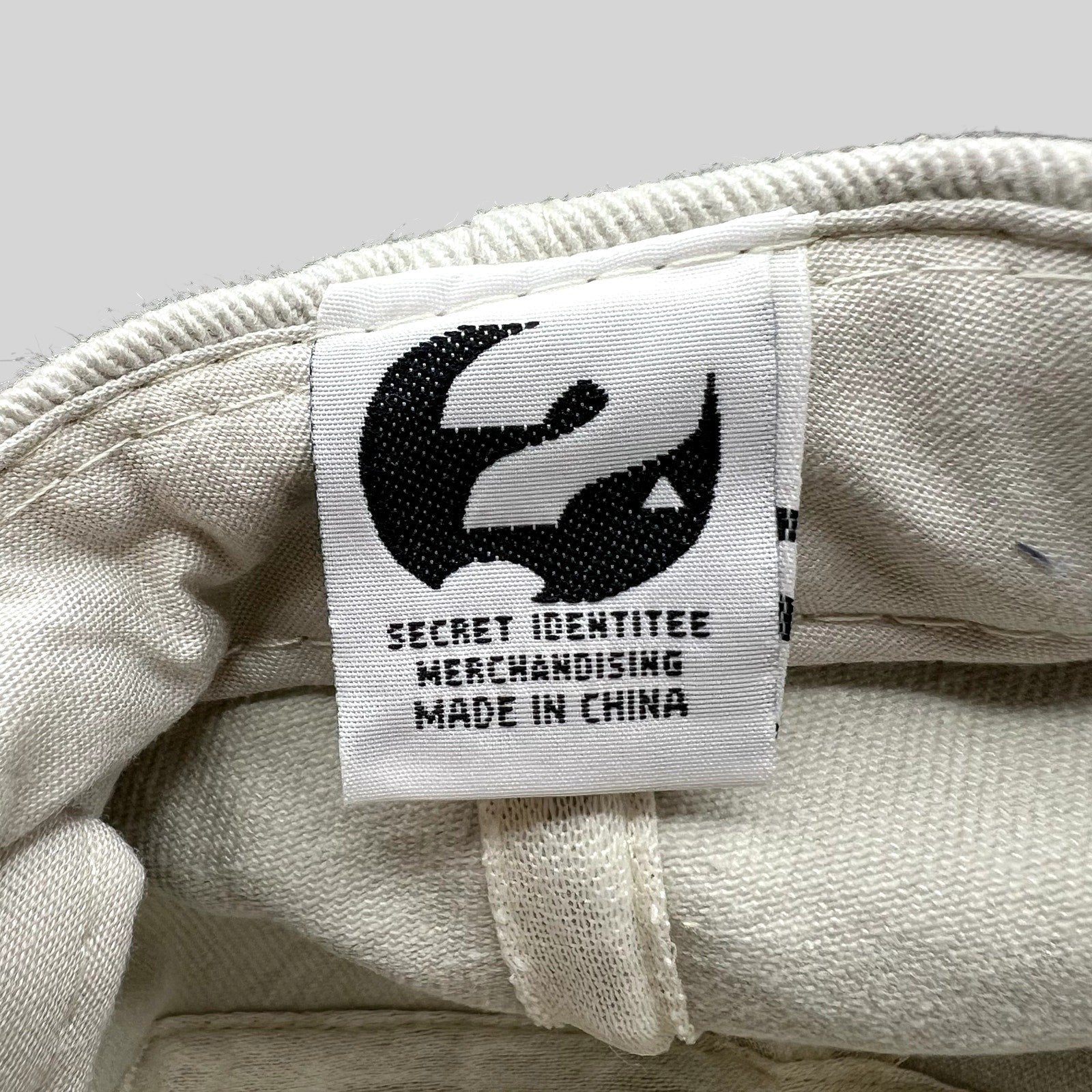Raree Finds vintage Melrose Place hat interior tag with Secret Identitee Merchandising logo and Made in China text.