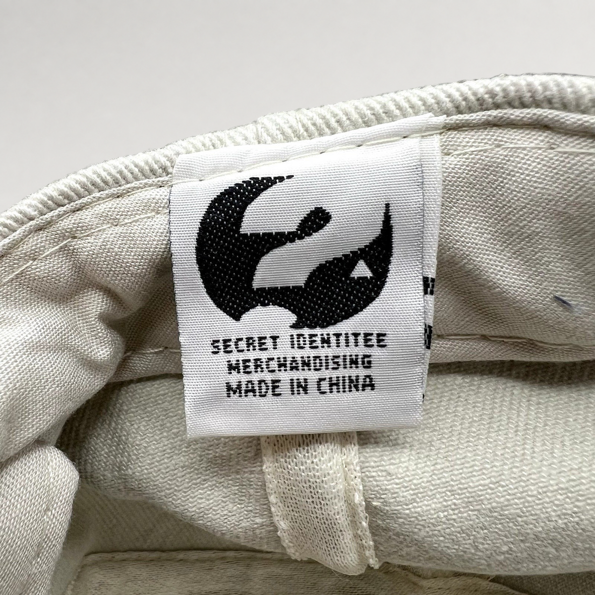 Raree Finds vintage Melrose Place hat interior tag with Secret Identitee Merchandising logo and Made in China text.