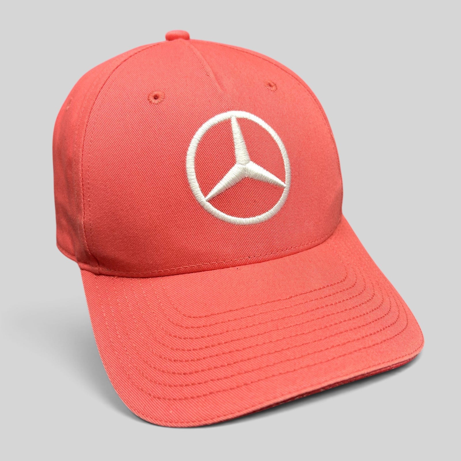 Raree Finds coral pink Mercedes AMG Petronas strapback hat with a large white embroidered Mercedes logo on the front.