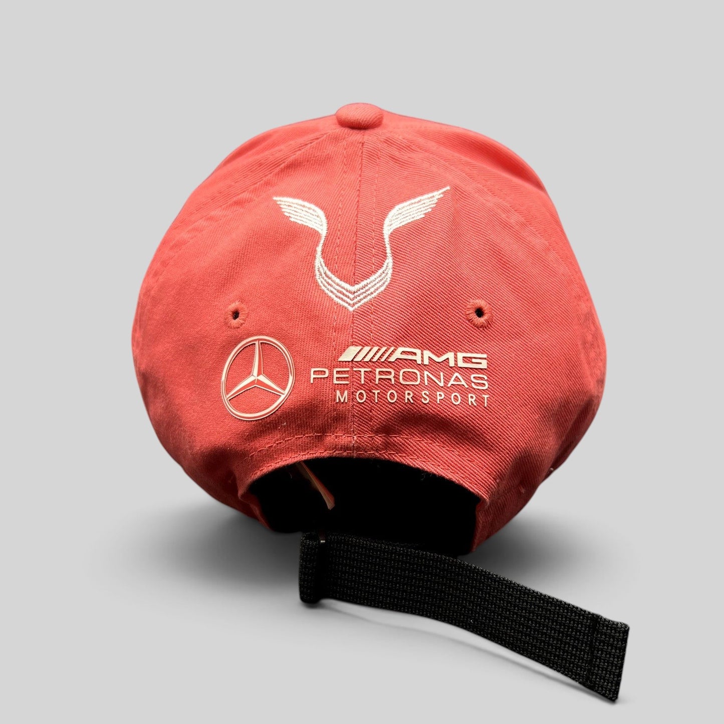 Raree Finds Mercedes AMG Petronas strapback hat in coral pink with white embroidered logos on the back