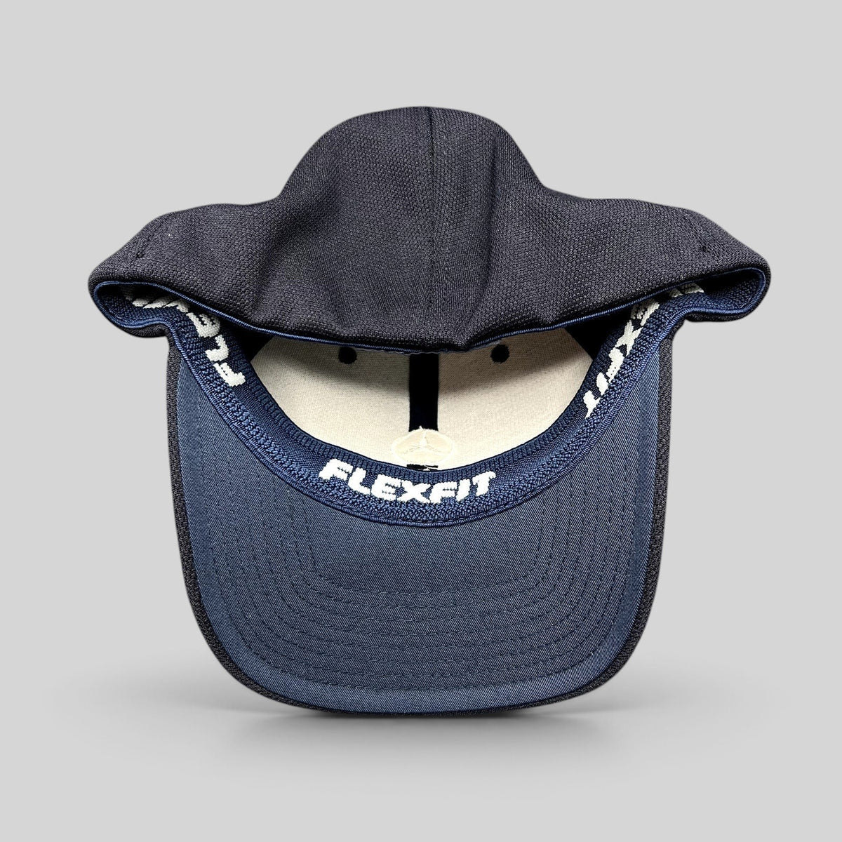 Raree Finds navy blue Mercedes-Benz Flexfit cap showing the interior sweatband with branded embroidery
