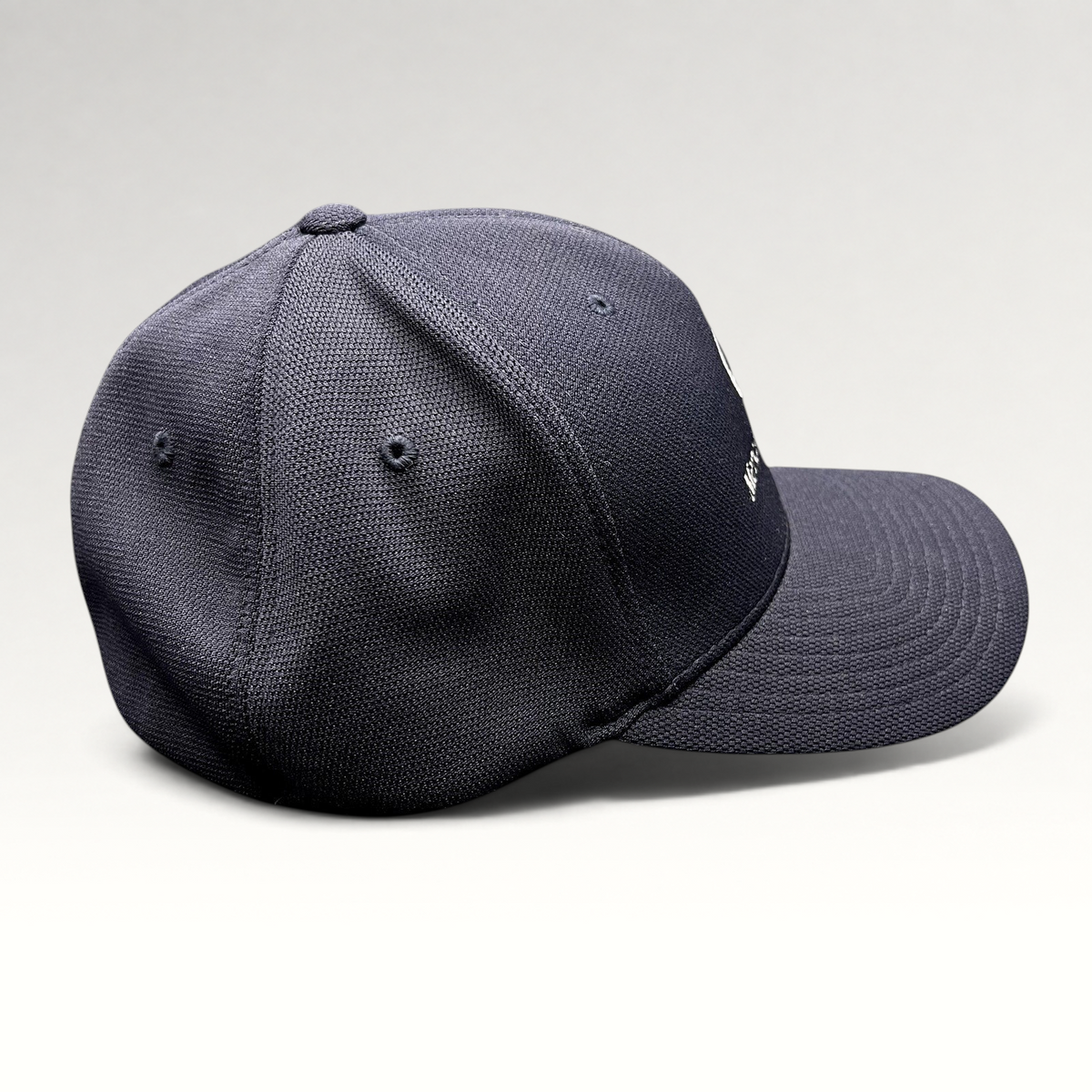 Raree Finds navy blue Mercedes-Benz Flexfit hat with embroidered logo and structured crown, side profile view.