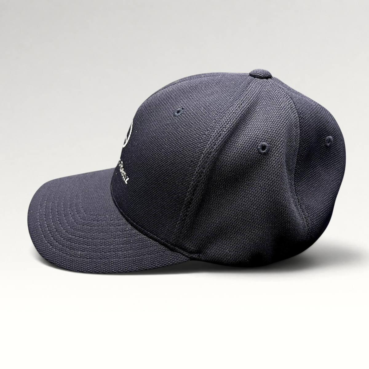 Raree Finds navy blue Mercedes-Benz Flexfit hat with embroidered logo and structured crown, side profile view.