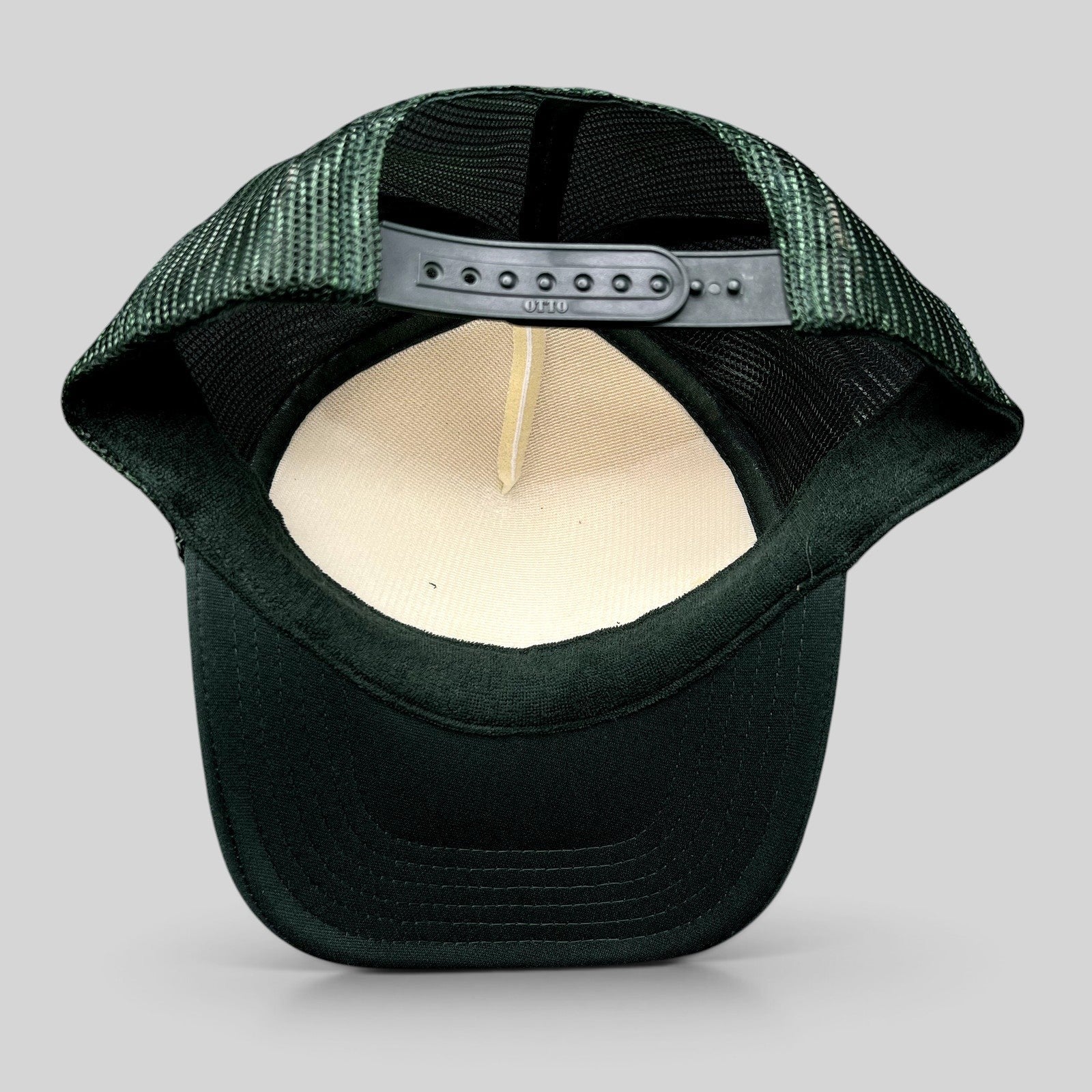Raree Finds Mesa Cafe Santa Barbara trucker hat showing the interior foam lining, dark green mesh, and snapback strap.