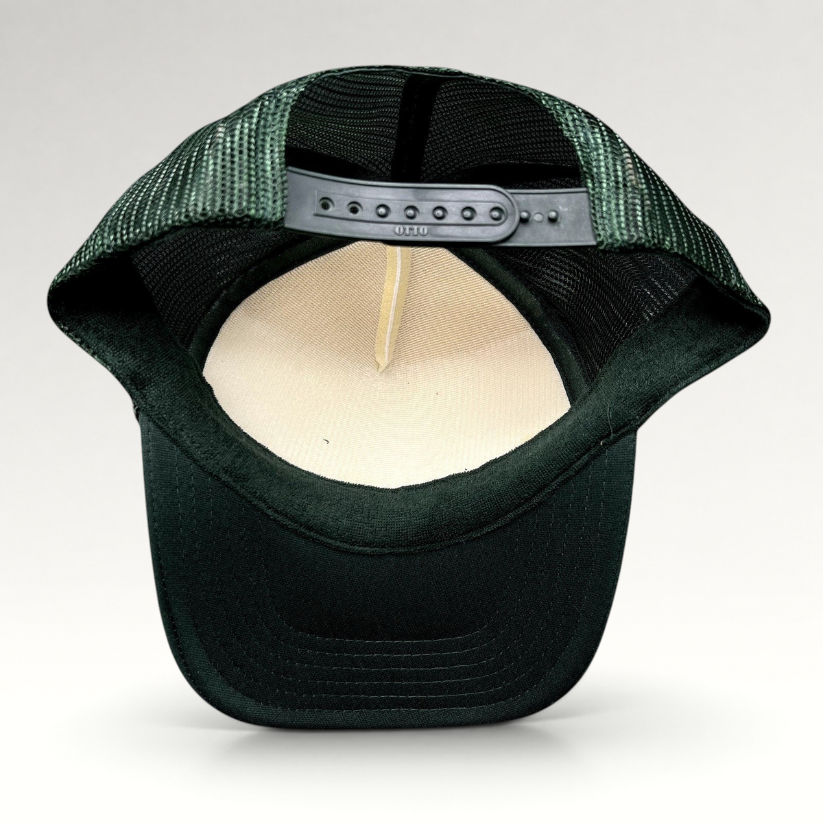 Raree Finds Mesa Cafe Santa Barbara trucker hat showing the interior foam lining, dark green mesh, and snapback strap.