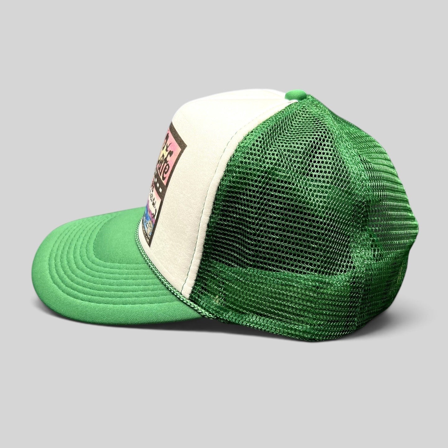 Raree Finds Mesa Cafe Santa Barbara trucker hat with green brim, white foam front, and green mesh back, side view.