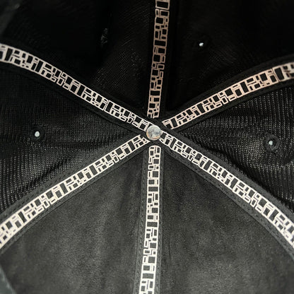 Interior view of a Raree Finds Metal Noir black strapback hat showing branded geometric pattern seam taping