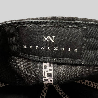Raree Finds Metal Noir black strapback hat interior label with white MN logo and brand name on black fabric
