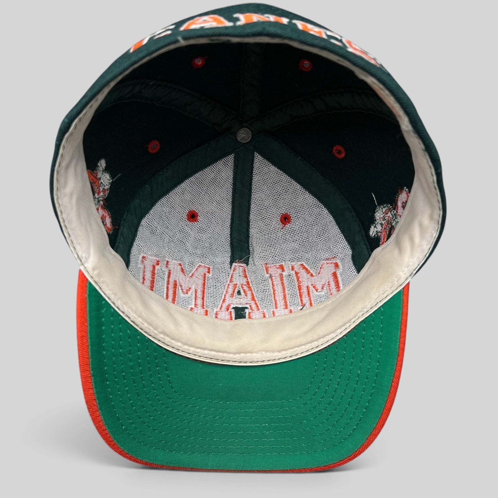 Raree Finds vintage Miami Hurricanes fitted hat interior showing green underbill and embroidered Miami logo detail