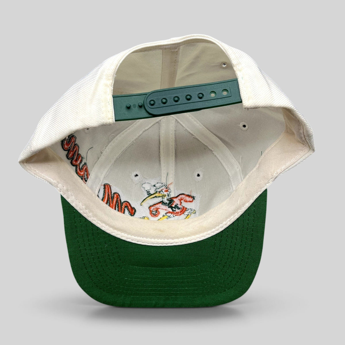 Raree Finds vintage Miami Hurricanes snapback hat with green brim and interior embroidery of Sebastian the Ibis