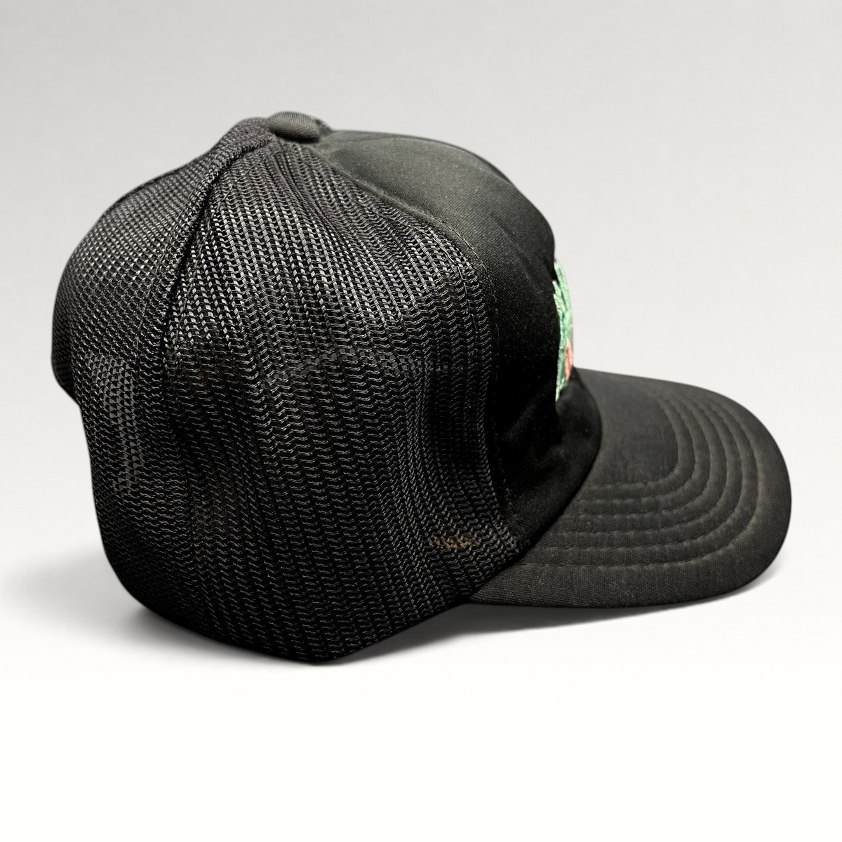 Raree Finds vintage Miami Vice black foam and mesh trucker hat with teal and pink embroidered logo, side view