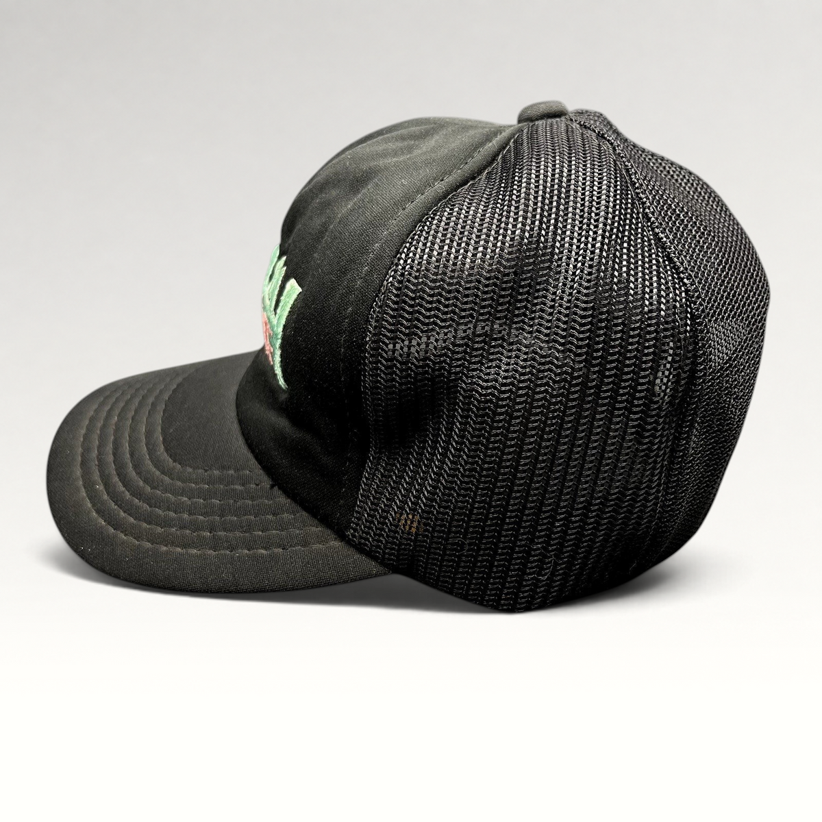 Raree Finds vintage Miami Vice black mesh trucker hat with teal and pink embroidered logo and snapback closure.