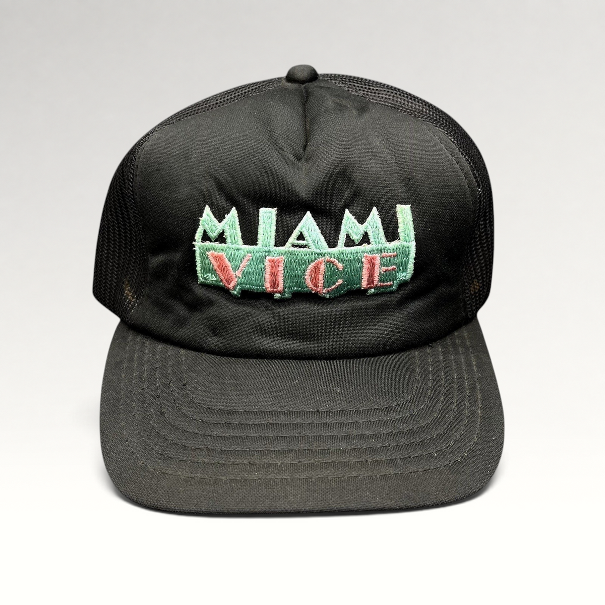Raree Finds vintage black Miami Vice trucker hat with teal and pink embroidered logo and mesh back