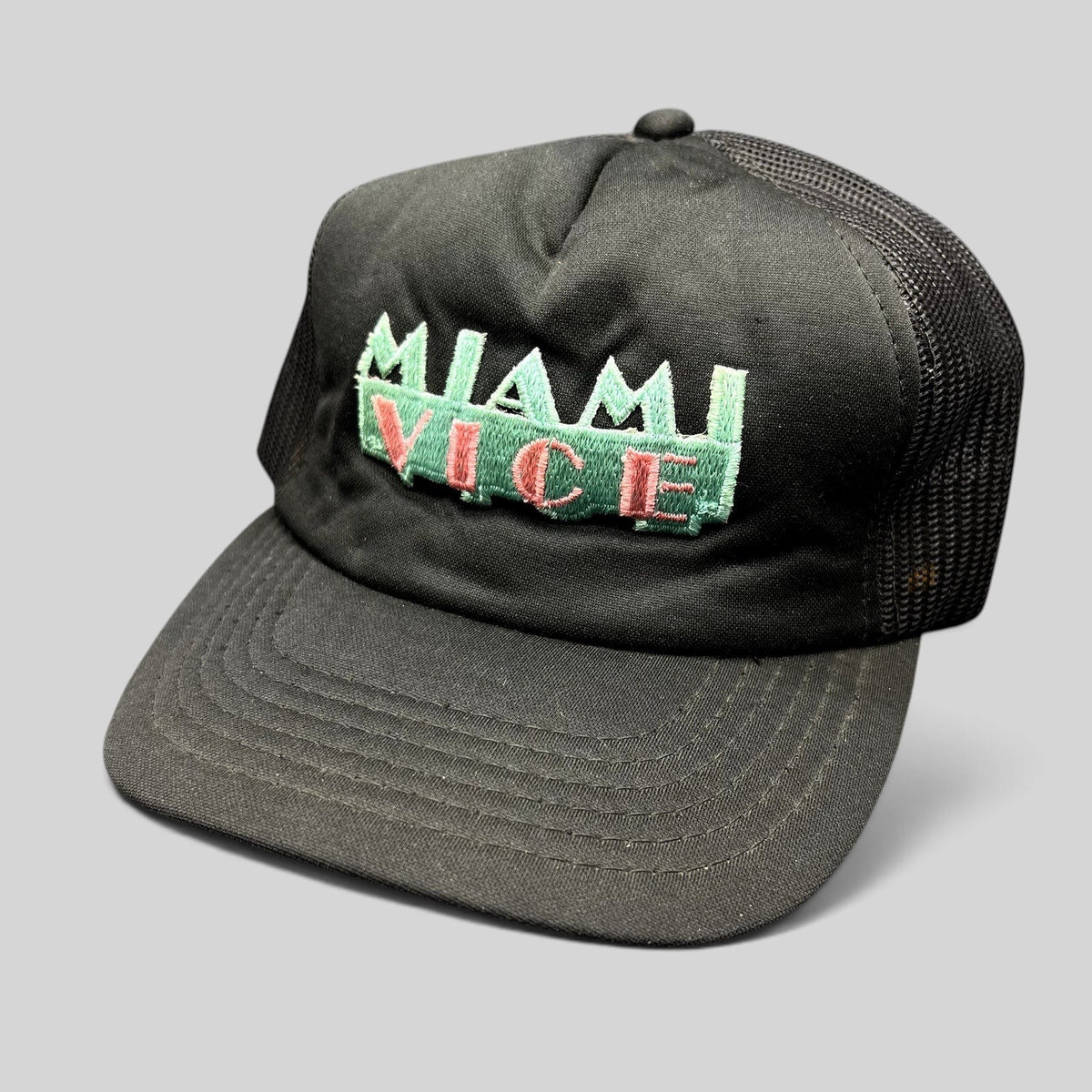Raree Finds vintage Miami Vice black foam and mesh trucker hat with teal and pink embroidered logo and snapback.
