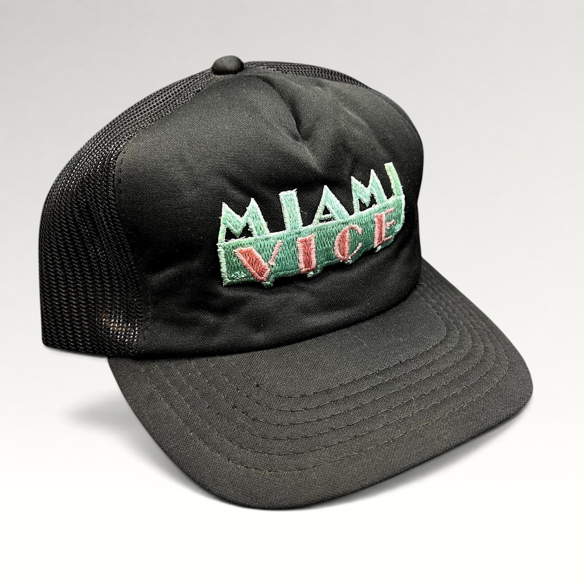 Raree Finds vintage Miami Vice black foam and mesh trucker hat with teal and pink embroidered logo