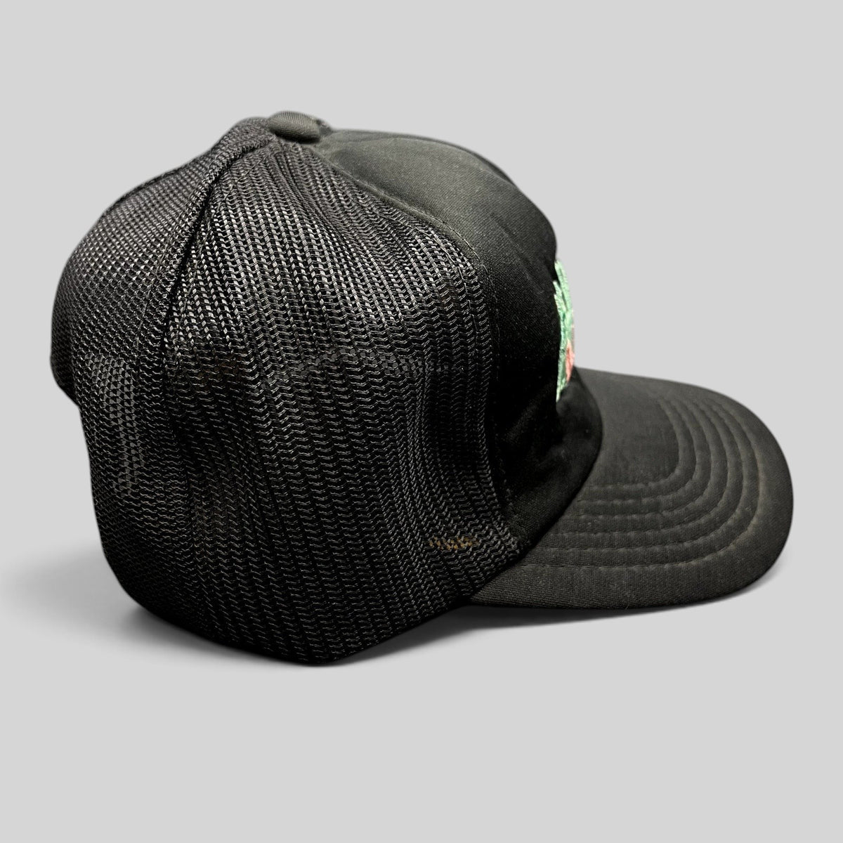 Raree Finds vintage Miami Vice black mesh trucker hat with teal and pink embroidered logo and snapback closure.