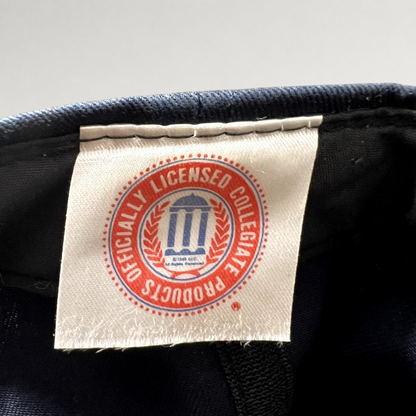 Raree Finds vintage Michigan Wolverines snapback hat interior tag showing the officially licensed collegiate logo