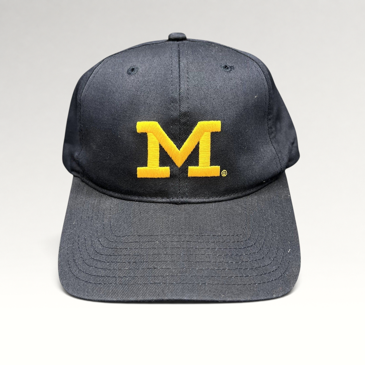 Raree Finds vintage Michigan Wolverines snapback hat in navy blue cotton with an embroidered maize Block M logo.