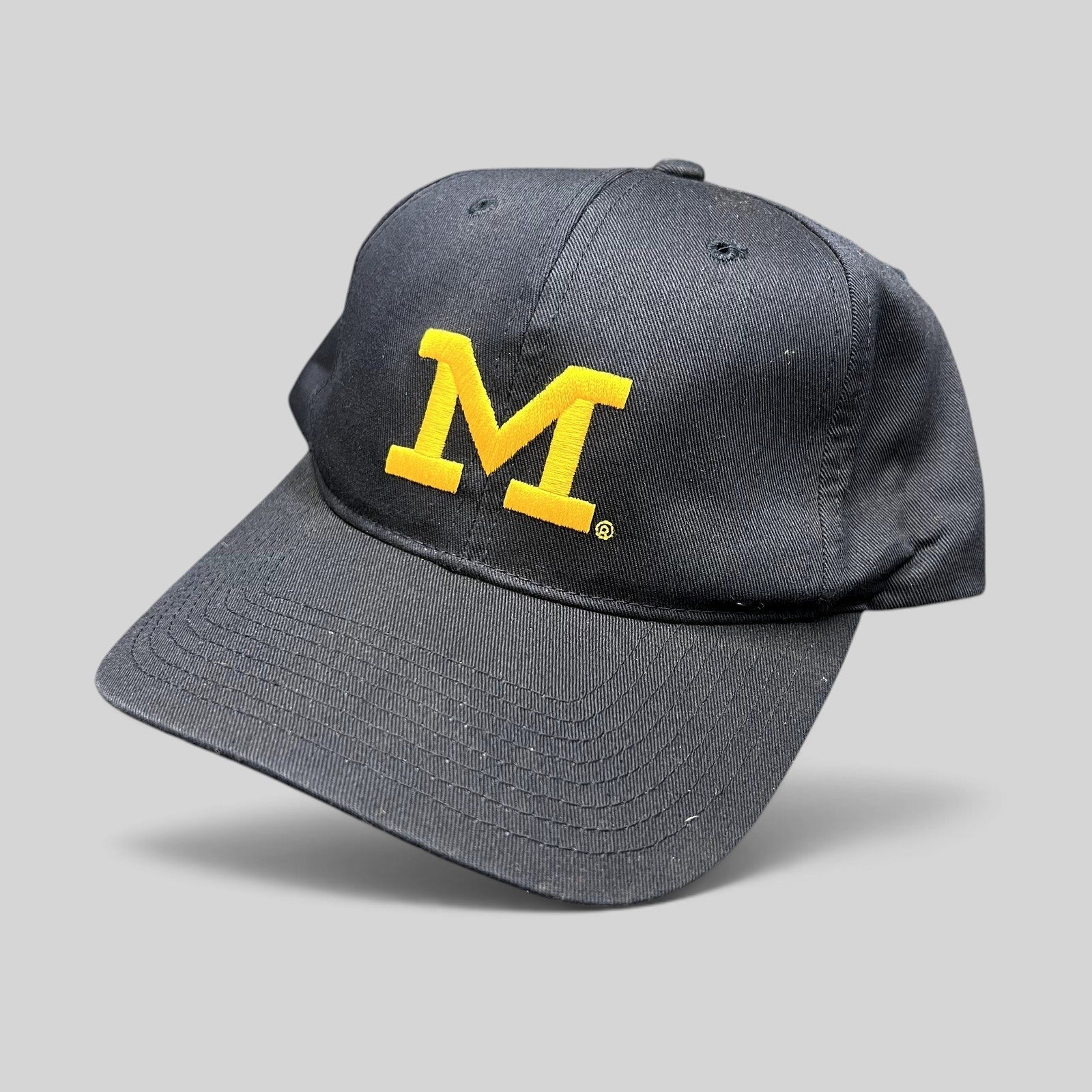 Raree Finds vintage Michigan Wolverines navy blue snapback hat with maize Block M embroidery and gray undervisor.