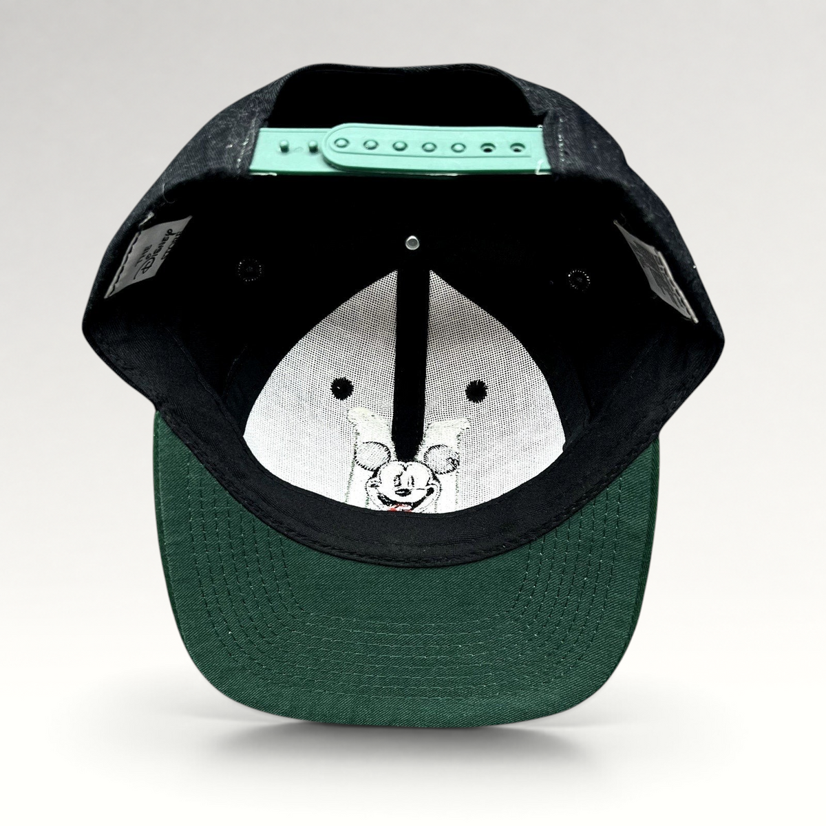 Raree Finds vintage 90s Disney Store Mickey Mouse snapback hat showing the green adjustable closure and inner lining