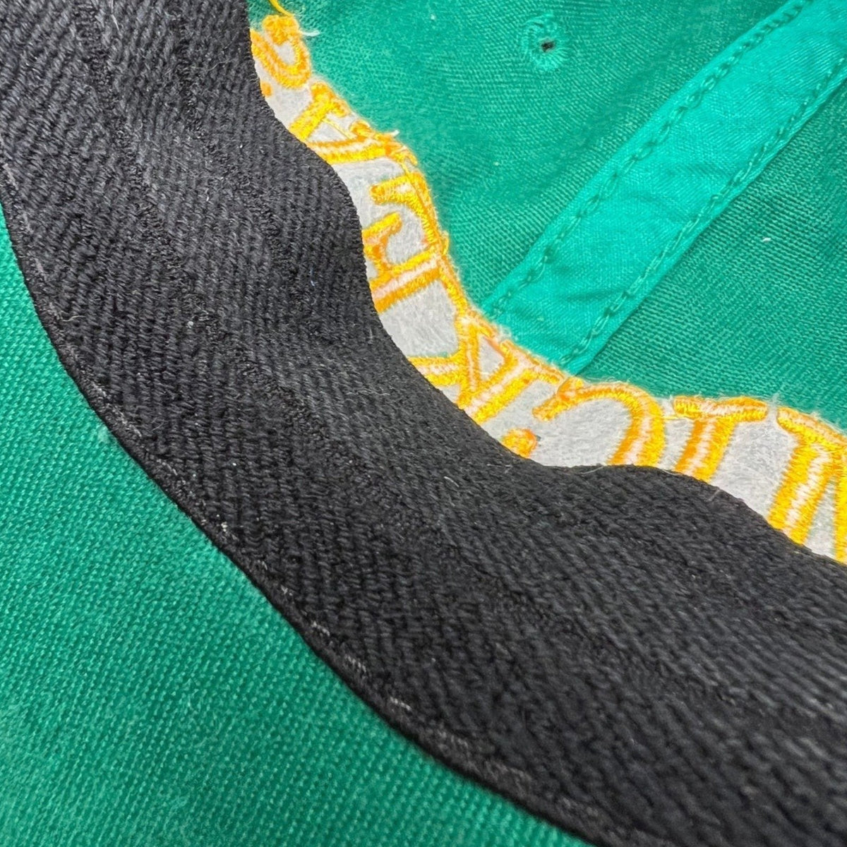 Raree Finds vintage 90s Mickey’s Malt Liquor cap interior showing green cotton fabric and black sweatband detail